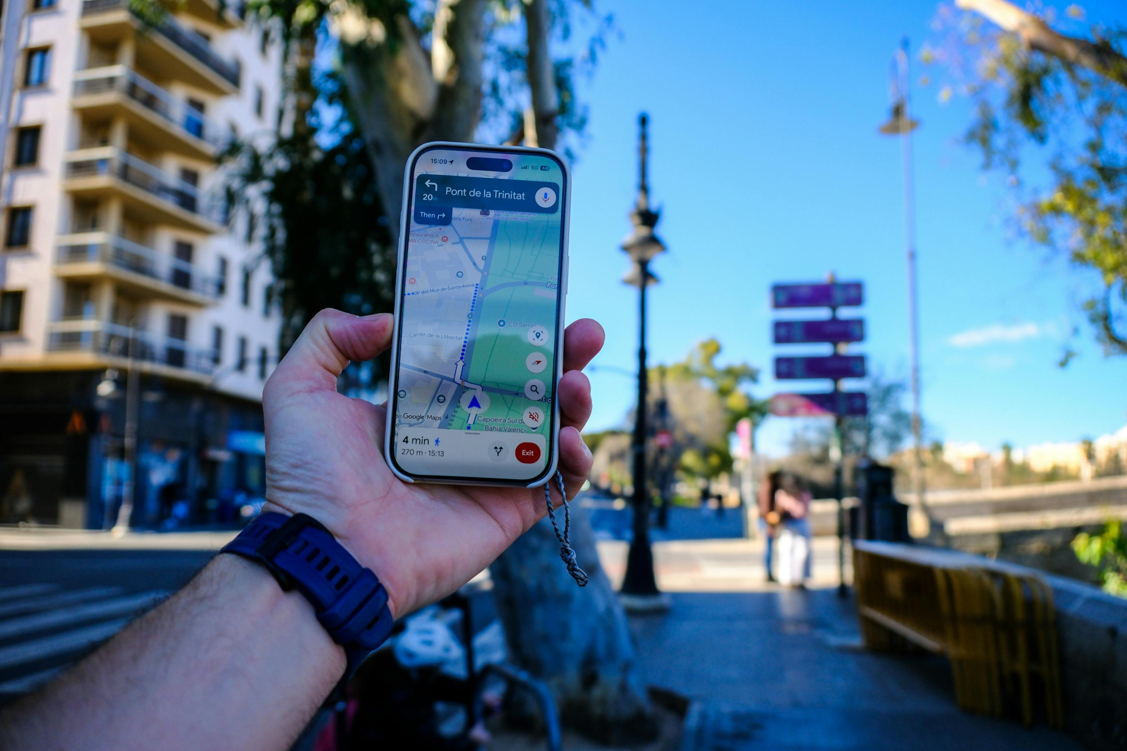 A person following a mobile phone map navigation tool whilst walking around a town - Google Maps street walk