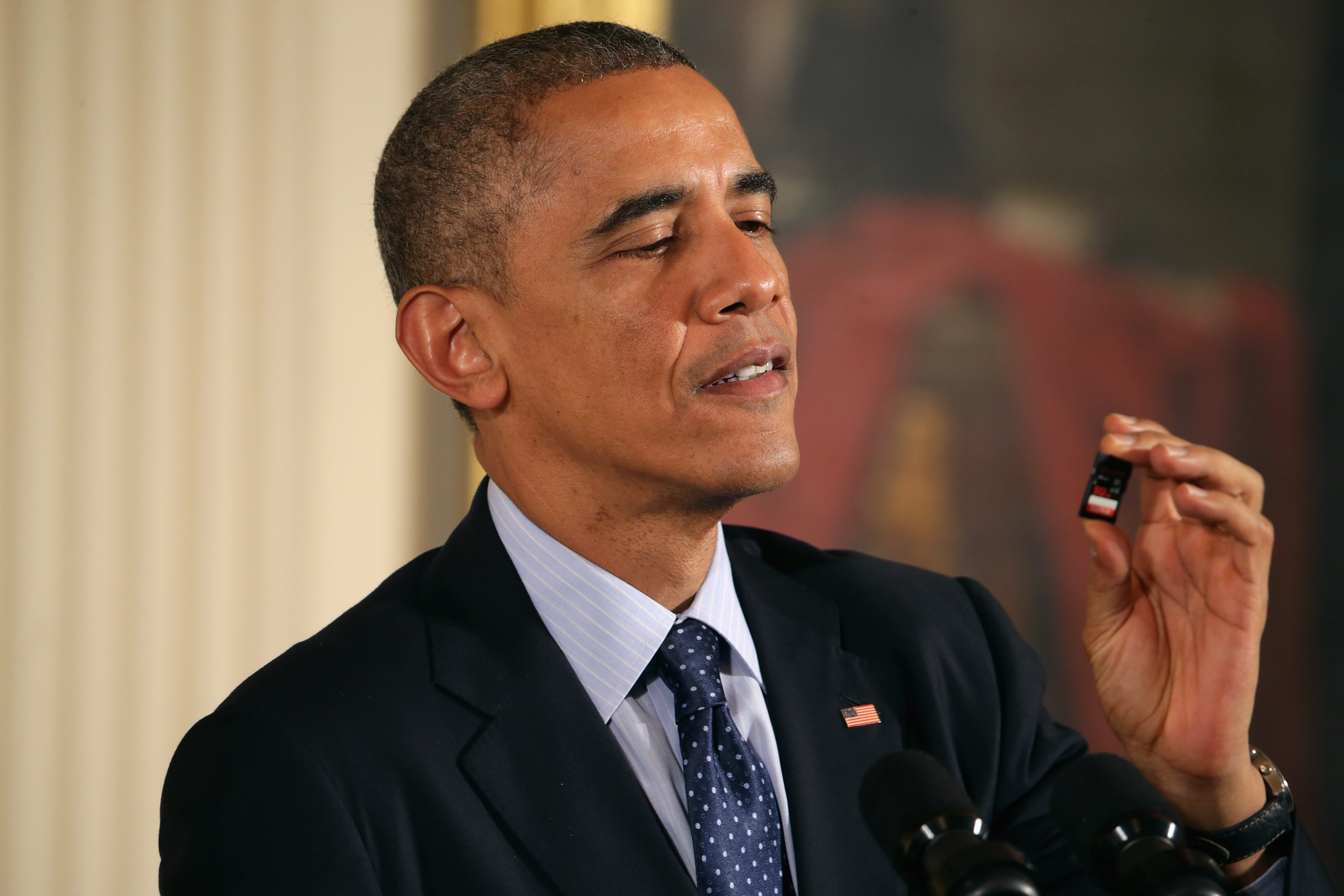 Barack Obama looking at a Sandisk flash card