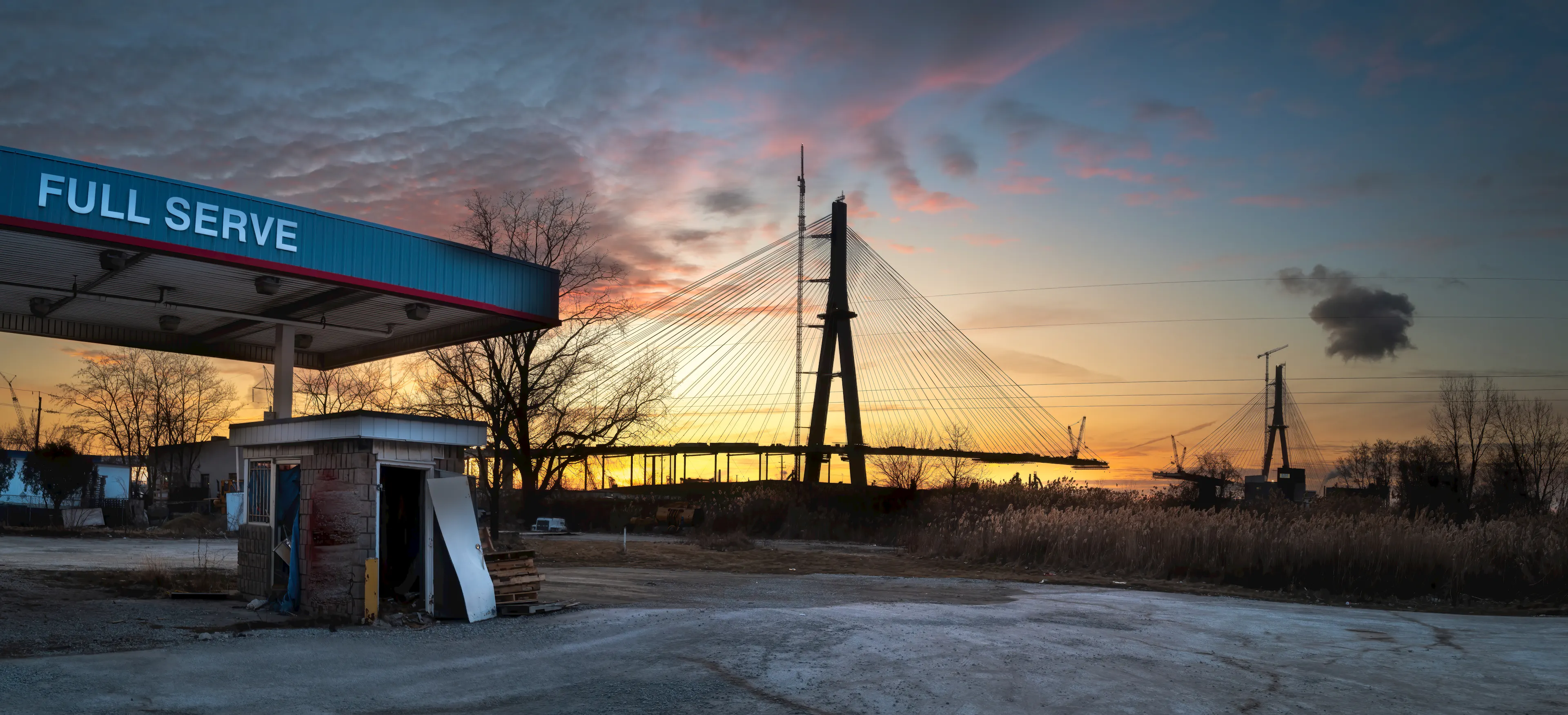 Gas station in front of the Gordie Howe International Bridge under construction.