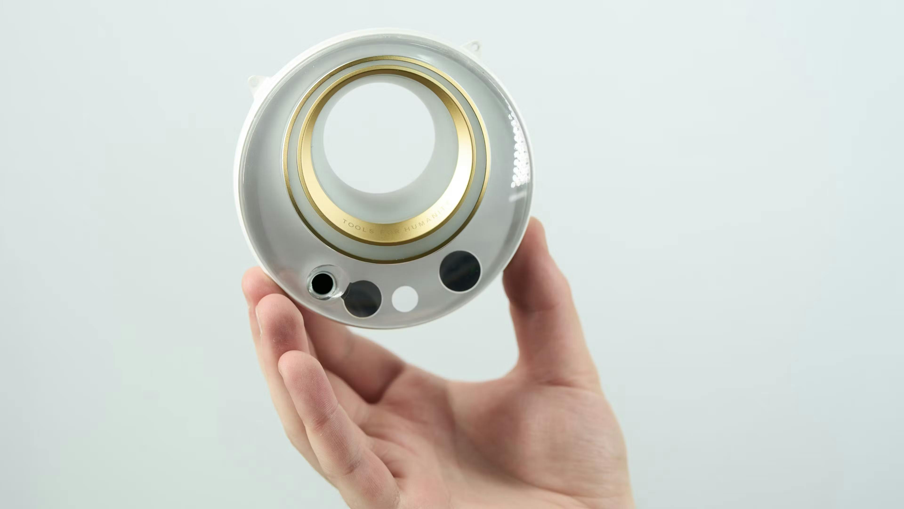 A hand holding the latest orb from World, formerly known as Worldcoin.